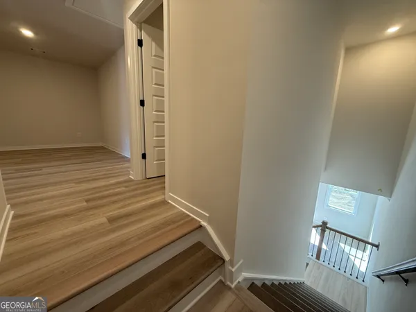 a view of an entryway with wooden floor