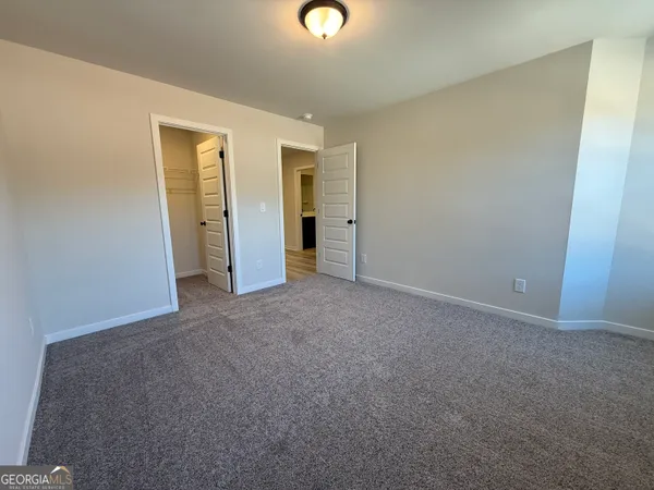 a view of a room with wooden floor and a sink