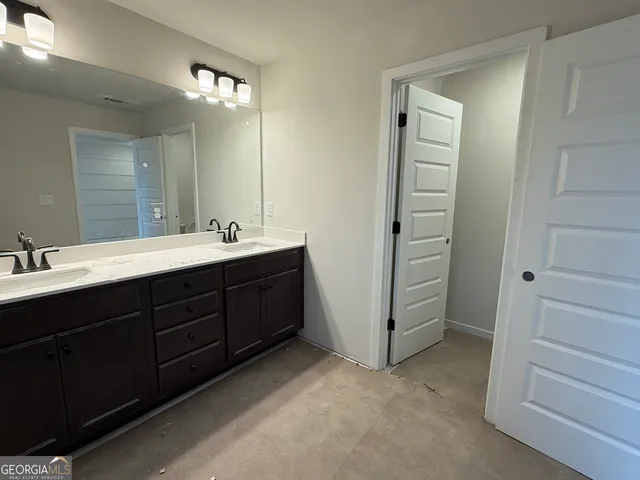 a bathroom with a double vanity sink a and mirror