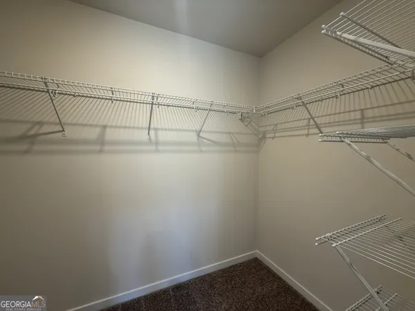 a bathroom with a double vanity sink a large mirror and shower