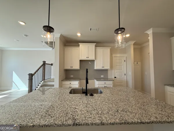 a view of a kitchen with a sink and refrigerator