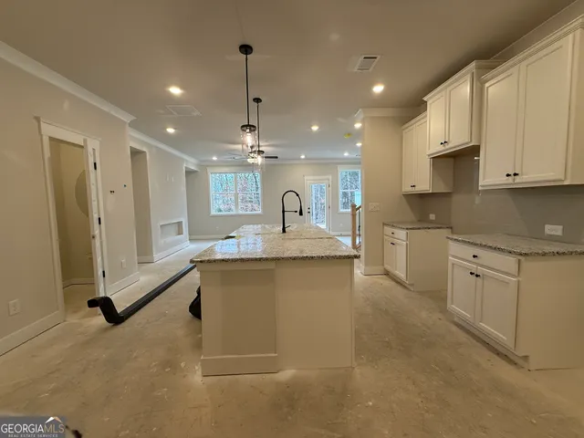 a kitchen with granite countertop a sink stainless steel appliances and cabinets