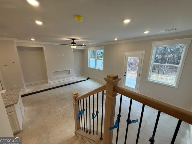 a view of a hallway with a window and wooden floor