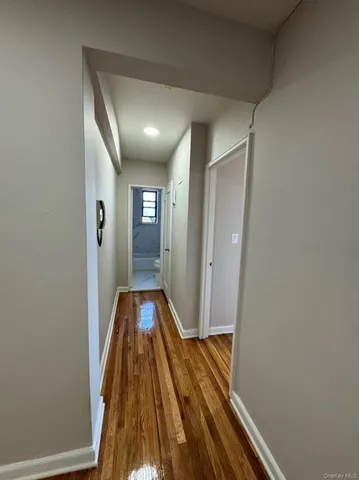 a view of hallway with wooden floor