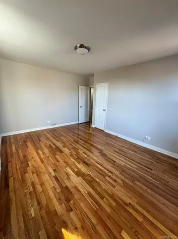 a view of an empty room and wooden floor