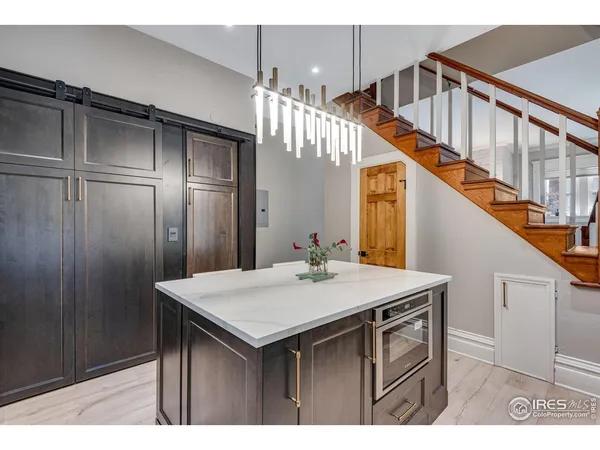 a kitchen with cabinets and wooden floor