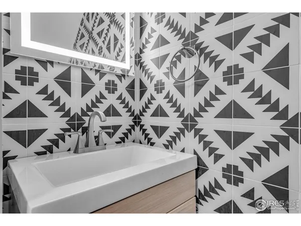 a kitchen with a wooden floor and cabinets