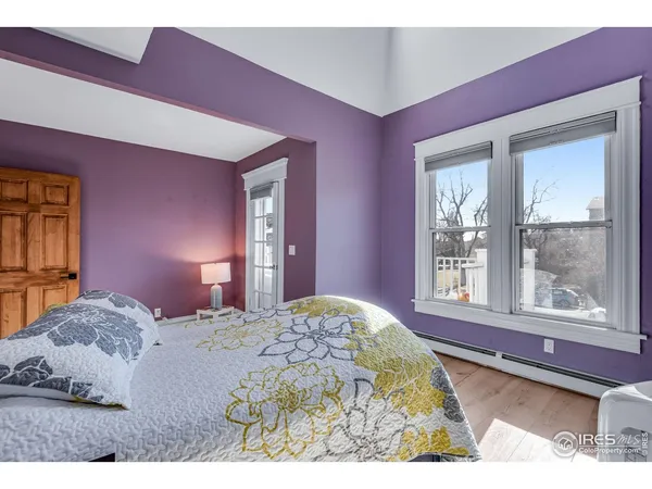 a bed room with a bed and a television