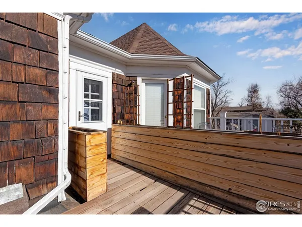 a view of balcony with wooden floor and fence