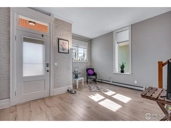 a view of a livingroom with furniture hardwood floor and a window