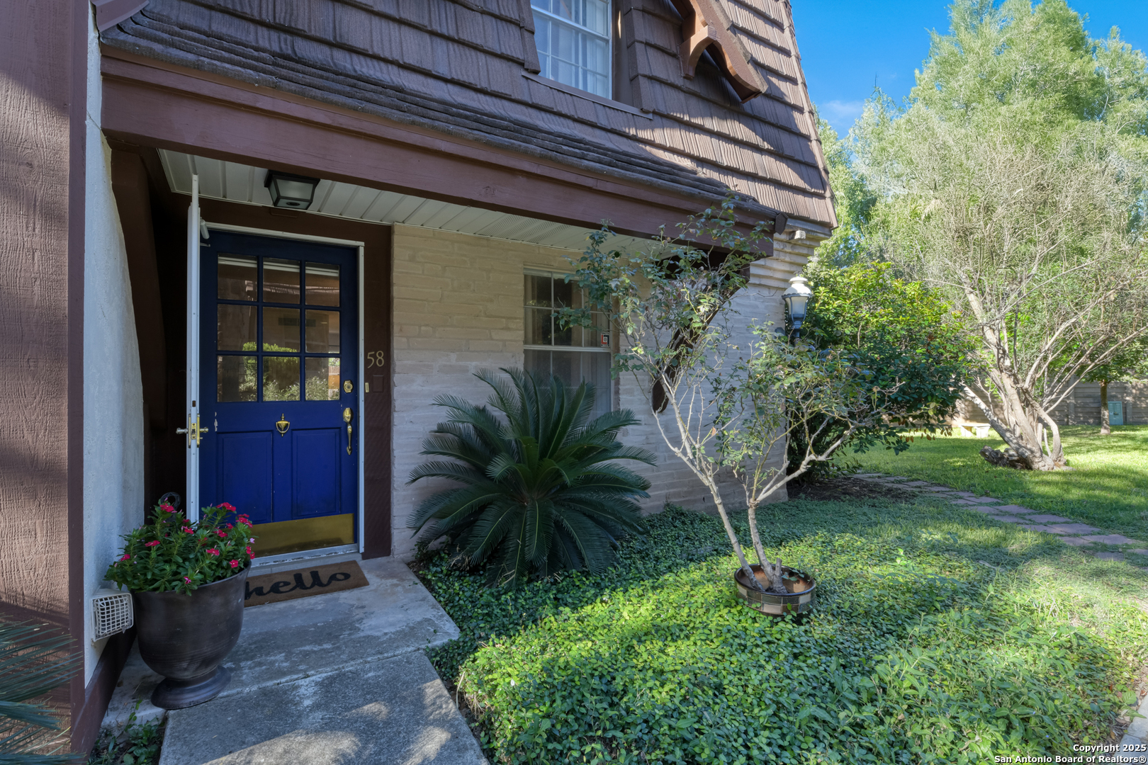 8715 Starcrest, Unit 58 San Antonio, TX 78217 - Photo 19 of 30 a front view of a house with garden