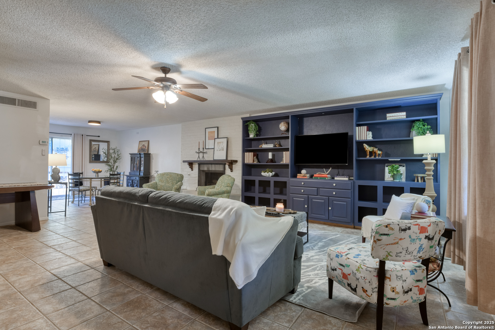 8715 Starcrest, Unit 58 San Antonio, TX 78217 - Photo 20 of 30 a living room with furniture and a flat screen tv