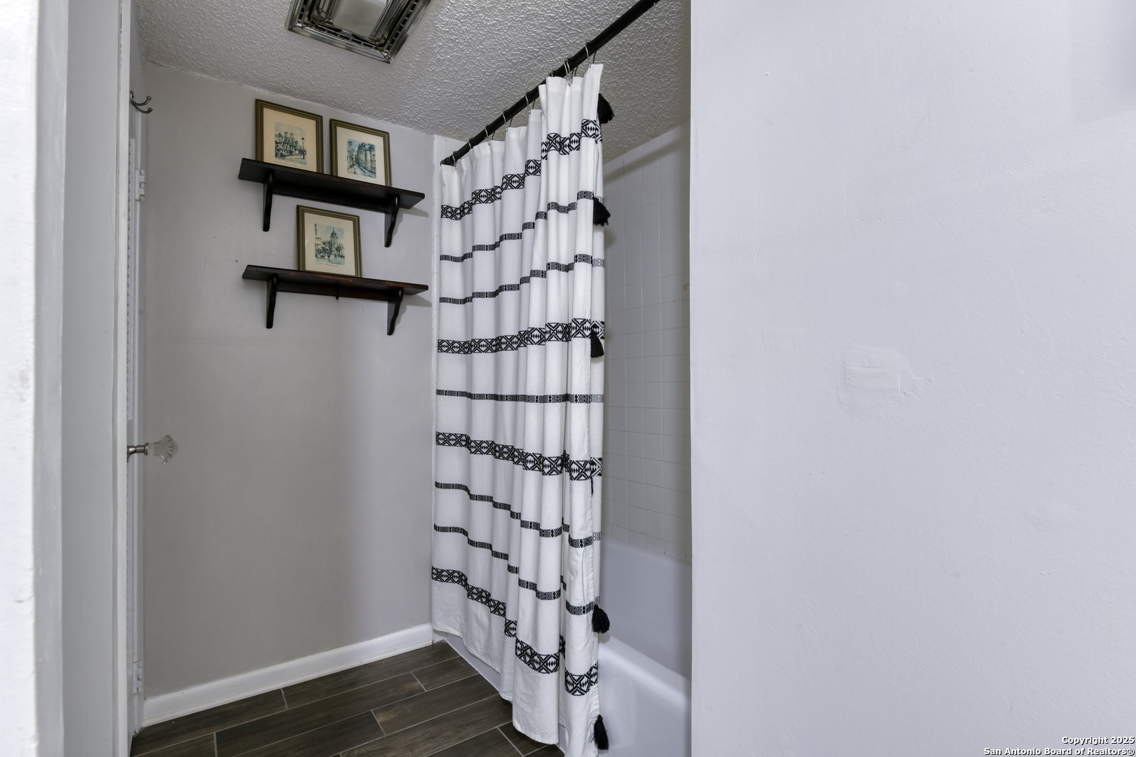 8715 Starcrest, Unit 58 San Antonio, TX 78217 - Photo 29 of 30 a view of a room with stairs and wooden floor