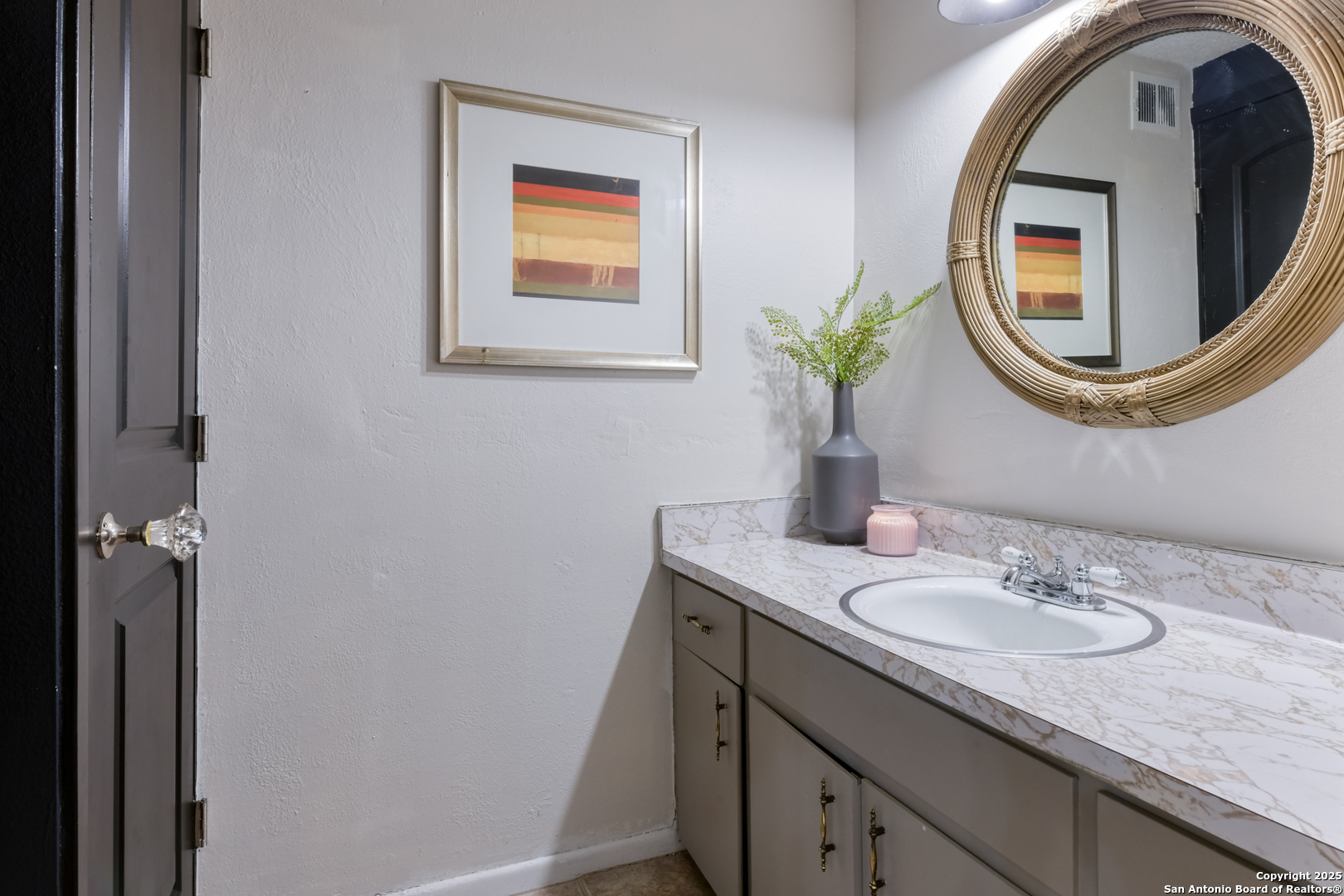 8715 Starcrest, Unit 58 San Antonio, TX 78217 - Photo 9 of 30 a bathroom with a granite countertop sink and a mirror