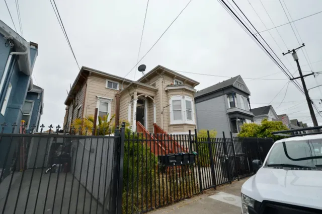 a view of a house with wooden fence