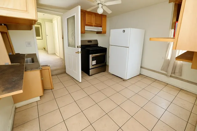 a kitchen with stainless steel appliances a refrigerator sink and stove