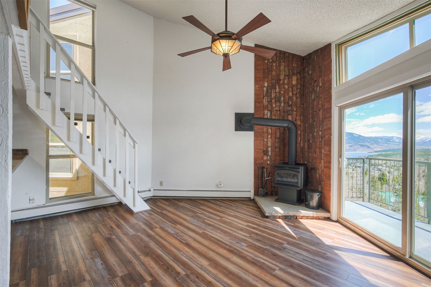 7031 Ryan Gulch Road, Unit 301 Silverthorne, CO 80498 - Photo 7 of 37 a view of an entryway with wooden floor a ceiling fan and windows