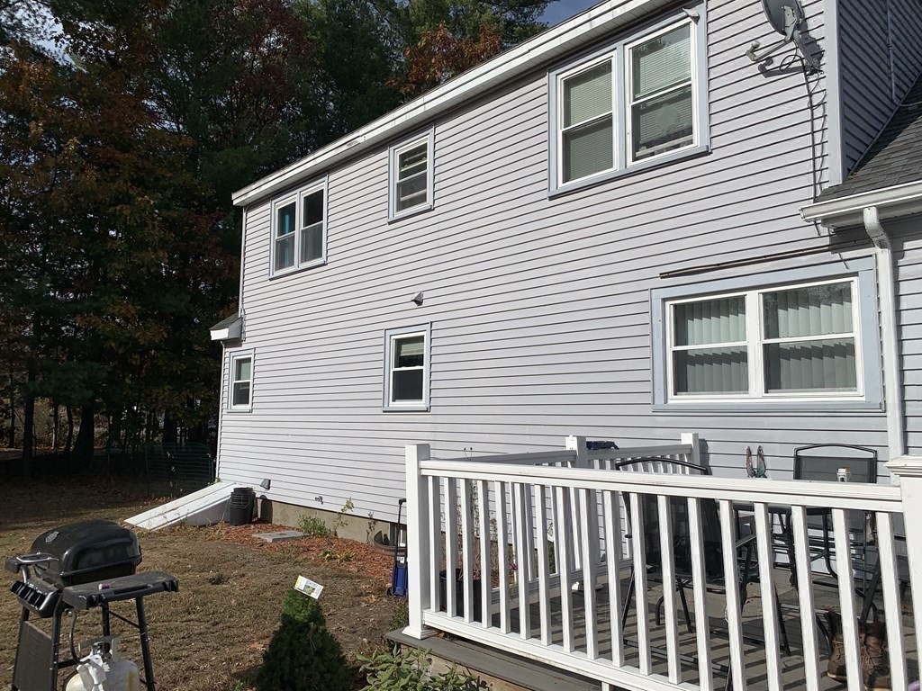63 Lowell Road Pepperell, MA 01463 - Photo 24 of 32 a front view of a house with a yard