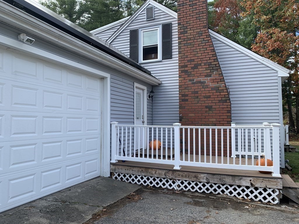 63 Lowell Road Pepperell, MA 01463 - Photo 3 of 32 a view of a wooden door with a bench