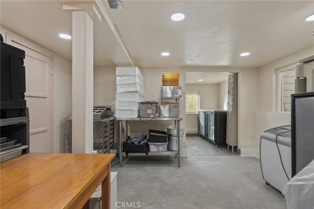 28670 Highway 18 Lake Arrowhead, CA 92385 - Photo 18 of 24 a kitchen with stainless steel appliances kitchen island granite countertop a refrigerator and a sink