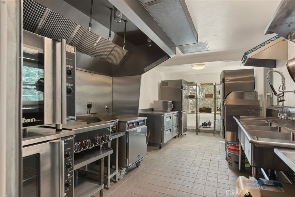 28670 Highway 18 Lake Arrowhead, CA 92385 - Photo 5 of 24 a kitchen with stainless steel appliances a stove a sink dishwasher and a refrigerator