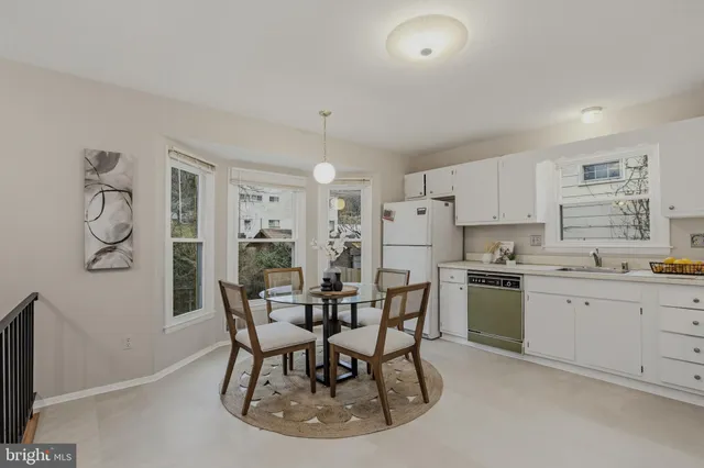 a kitchen with granite countertop cabinets and chairs