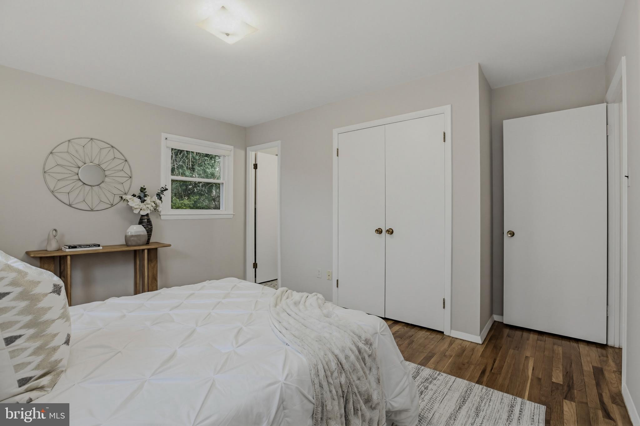 404 Ritchie Parkway Rockville, MD 20852 - Photo 16 of 38 a bedroom with a large bed and wooden floor