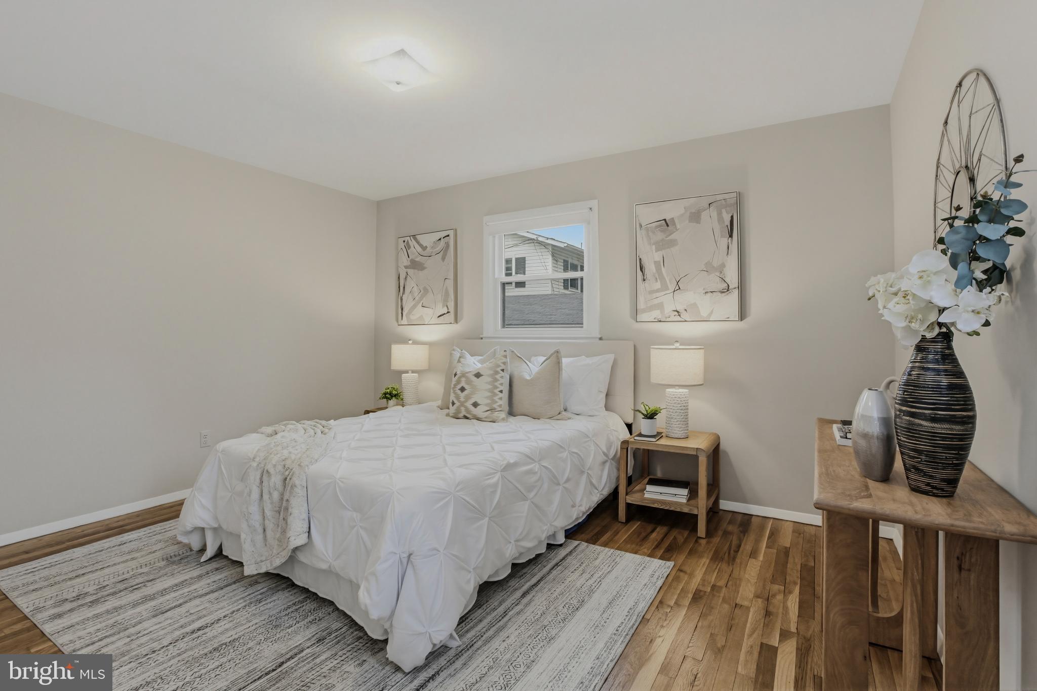 404 Ritchie Parkway Rockville, MD 20852 - Photo 17 of 38 a bedroom with a bed and wooden floor