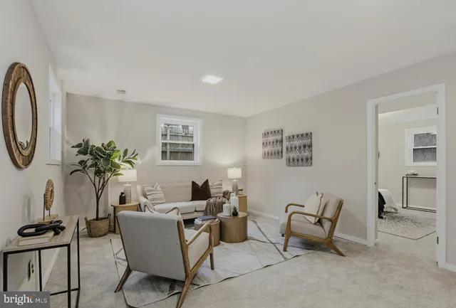 a view of living room with furniture and a potted plant