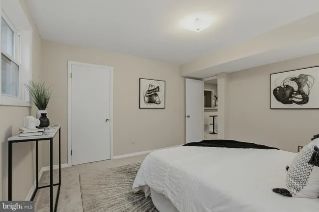 a bedroom with a bed and a lamp on table