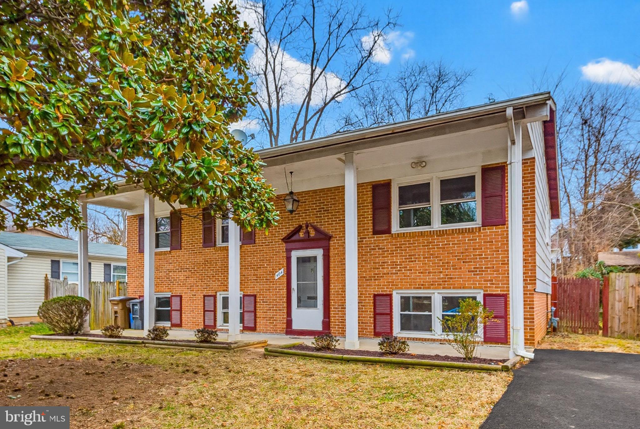 404 Ritchie Parkway Rockville, MD 20852 - Photo 3 of 38 a front view of a house with large tree and wooden fence
