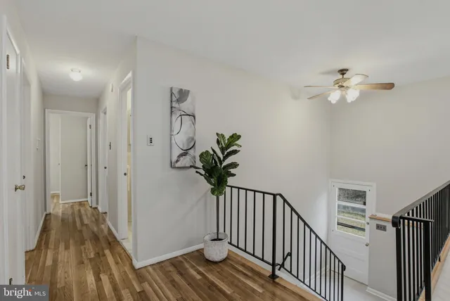a view of a hallway with wooden floor