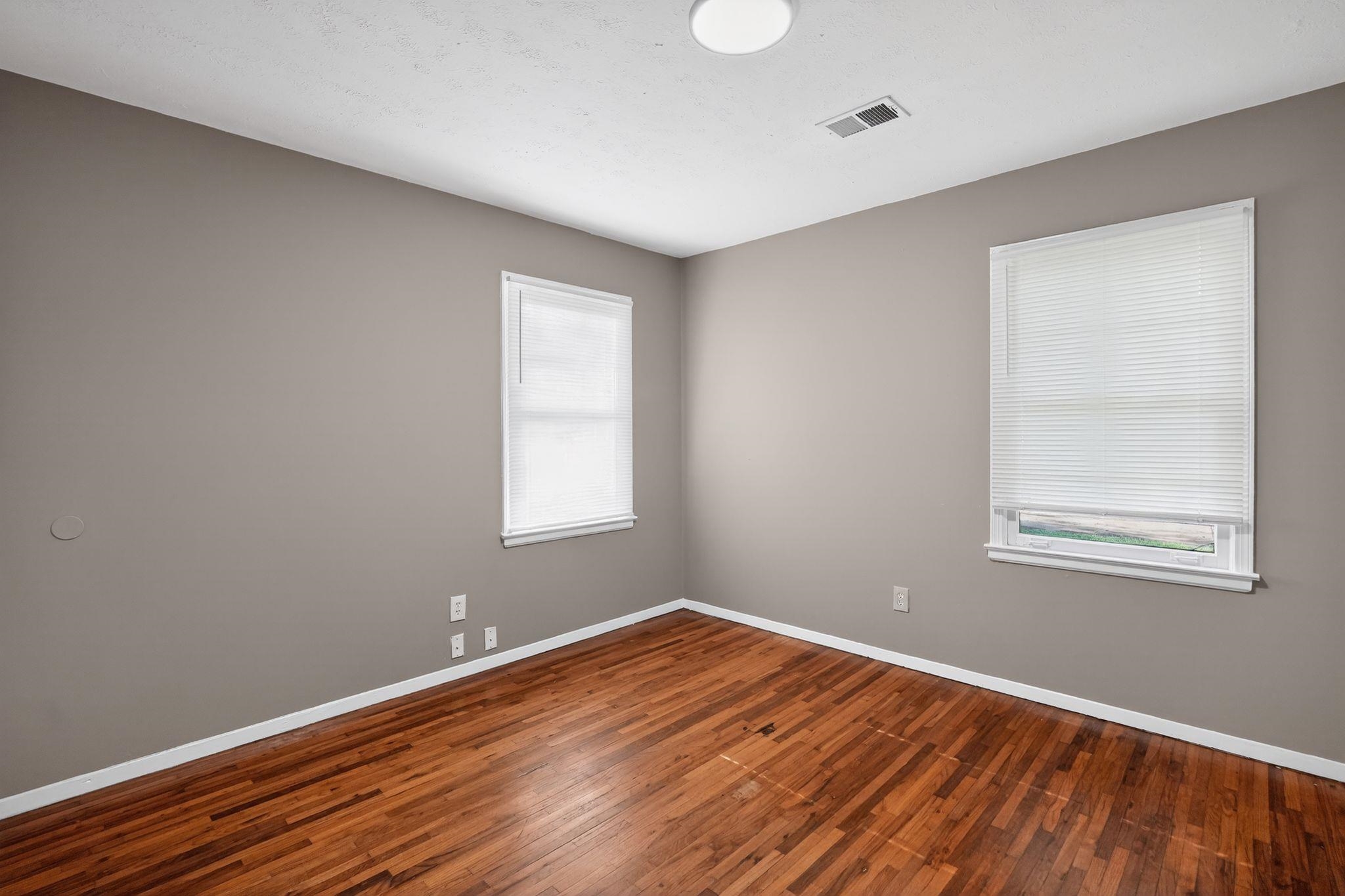 4955 Stacey Road Memphis, TN 38109 - Photo 14 of 35 Warm wood-finish flooring complements the neutral wall color