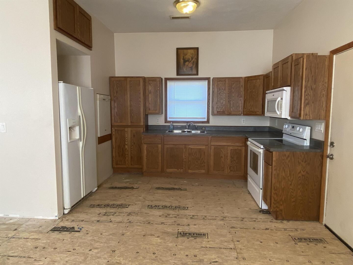 190 Public Street Muddy, IL 62965 - Photo 4 of 16 a kitchen with stainless steel appliances granite countertop a refrigerator stove and sink