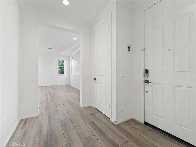 a view of a hallway with wooden floor