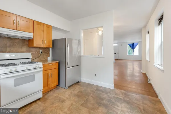 a kitchen with a refrigerator sink stove and cabinets