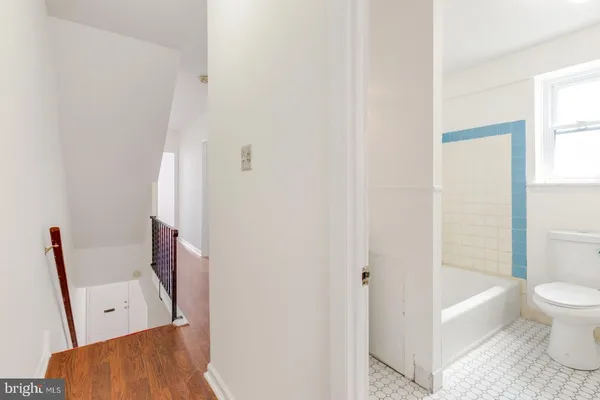 a bathroom with a tub and toilet