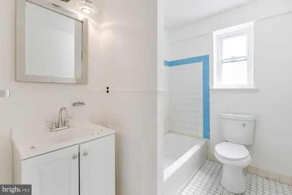 a bathroom with a sink a toilet and bathtub