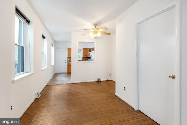 a view of a hallway with wooden floor