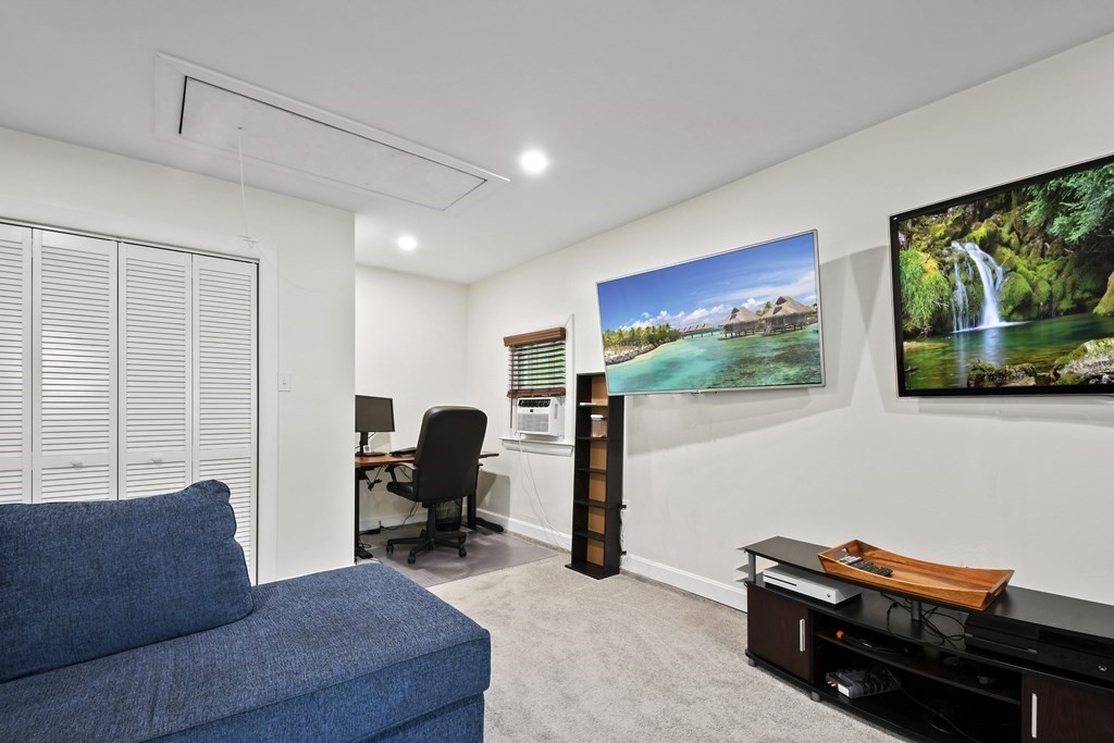 22 Ox Road Billerica, MA 01821 - Photo 15 of 26 a living room with furniture and a flat screen tv