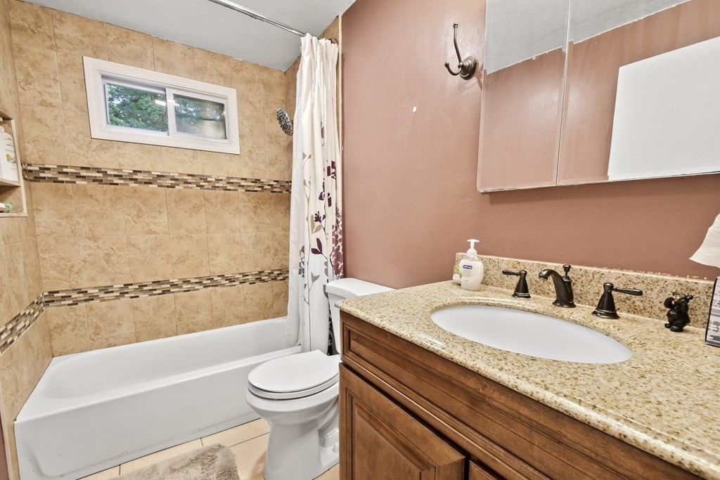 22 Ox Road Billerica, MA 01821 - Photo 19 of 26 a bathroom with a granite countertop sink toilet and shower