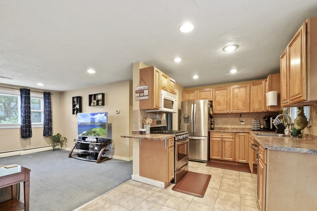 22 Ox Road Billerica, MA 01821 - Photo 3 of 26 a kitchen with stainless steel appliances kitchen island granite countertop a refrigerator and stove top oven with a dishwasher