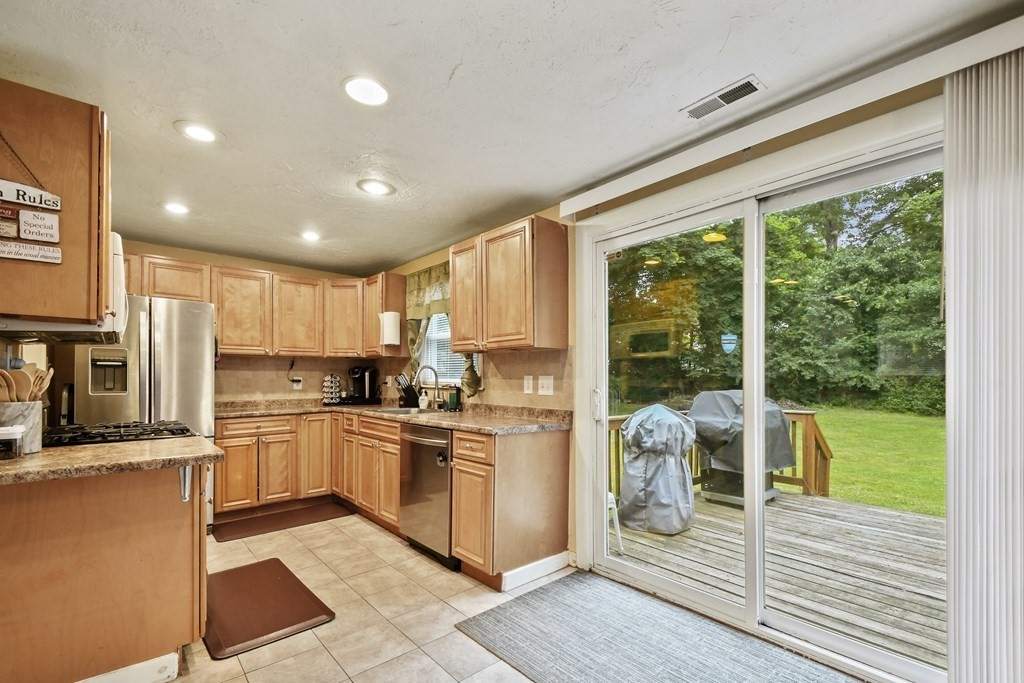 22 Ox Road Billerica, MA 01821 - Photo 4 of 26 a kitchen with a stove a sink and a refrigerator