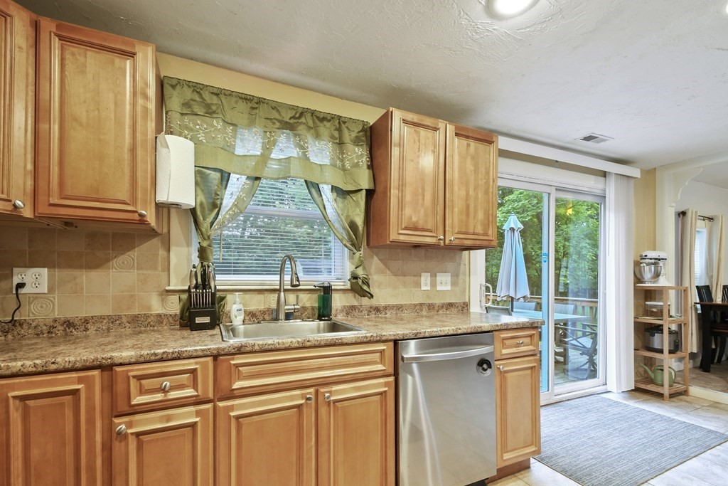 22 Ox Road Billerica, MA 01821 - Photo 5 of 26 a kitchen with stainless steel appliances granite countertop a stove a sink and a counter space