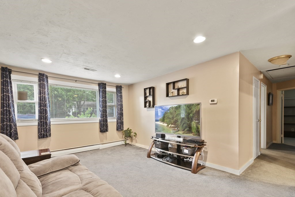 22 Ox Road Billerica, MA 01821 - Photo 7 of 26 a living room with furniture and a flat screen tv