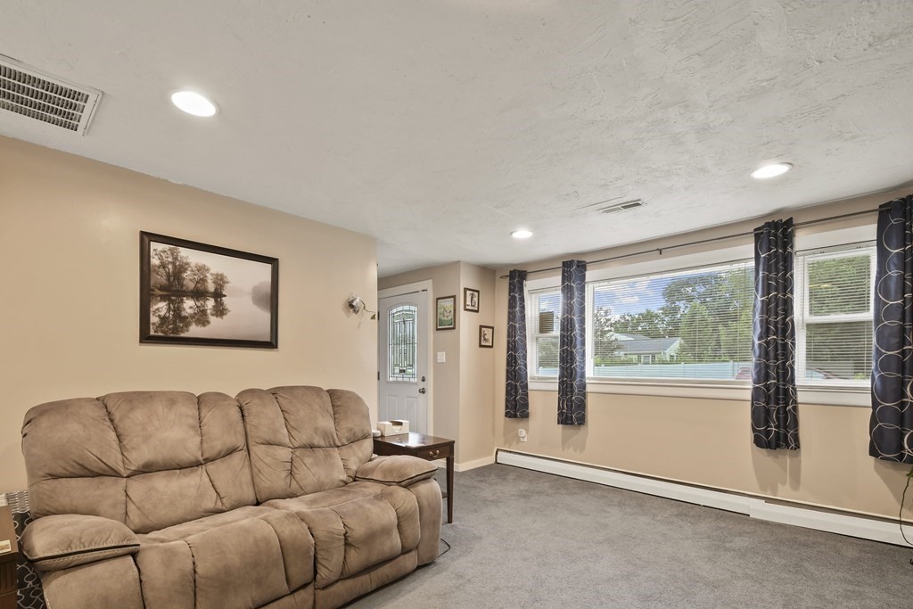 22 Ox Road Billerica, MA 01821 - Photo 8 of 26 a living room with furniture and a large window