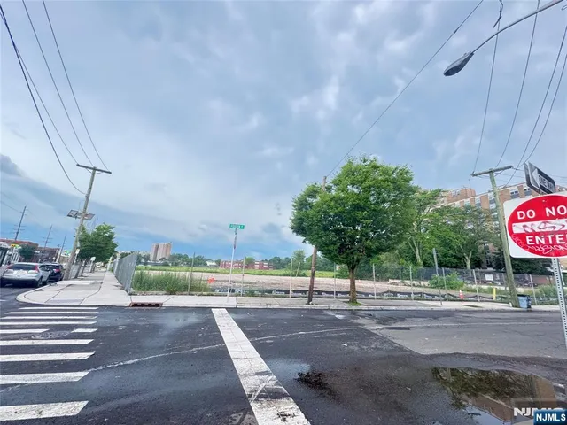 a view of a street with a building in the background