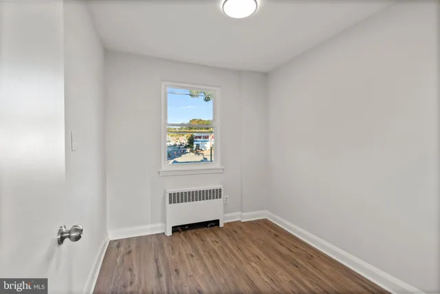 a view of an empty room and wooden floor