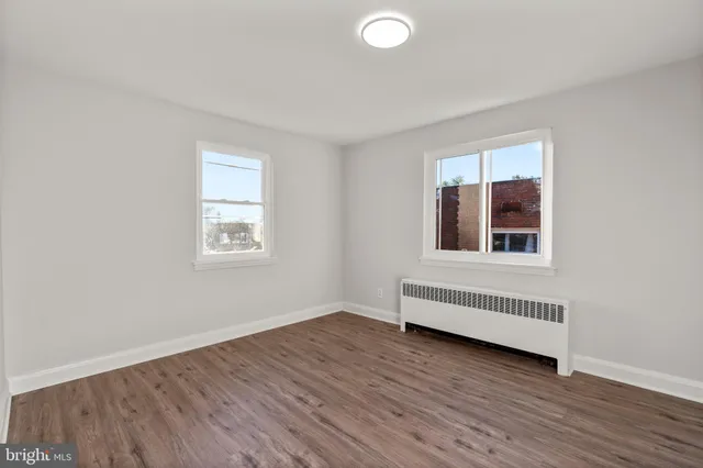 a view of a livingroom with wooden floor and a window