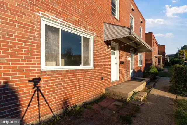 a view of a brick house with a yard